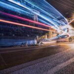 Vibrant night shot capturing dynamic light trails on a city street.