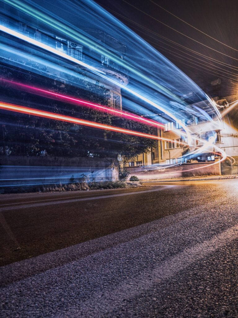Vibrant night shot capturing dynamic light trails on a city street.