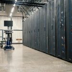 Steel framework cabinets housing servers networking devices and cables in contemporary equipped data center