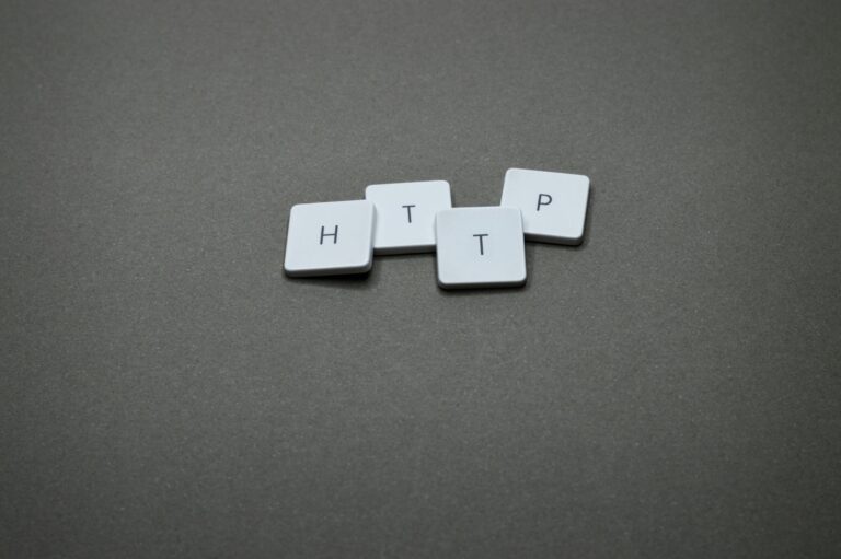 High-angle photo of keyboard tiles spelling HTTP on a dark background.