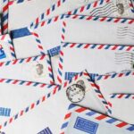 A close-up of vintage airmail envelopes with stamps and postmarks, showcasing nostalgic design.