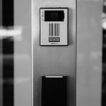 Minimalist black and white photo of an intercom system on a building facade in Boise.